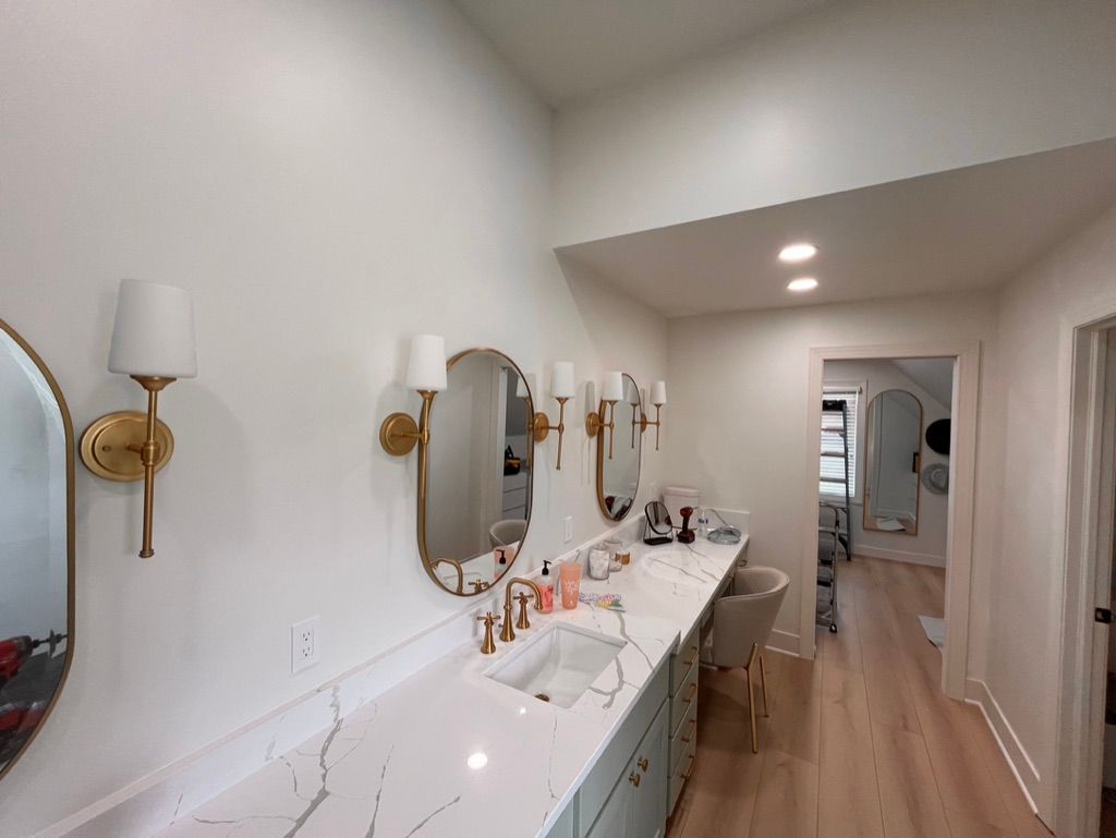 A bathroom with two sinks and two mirrors.