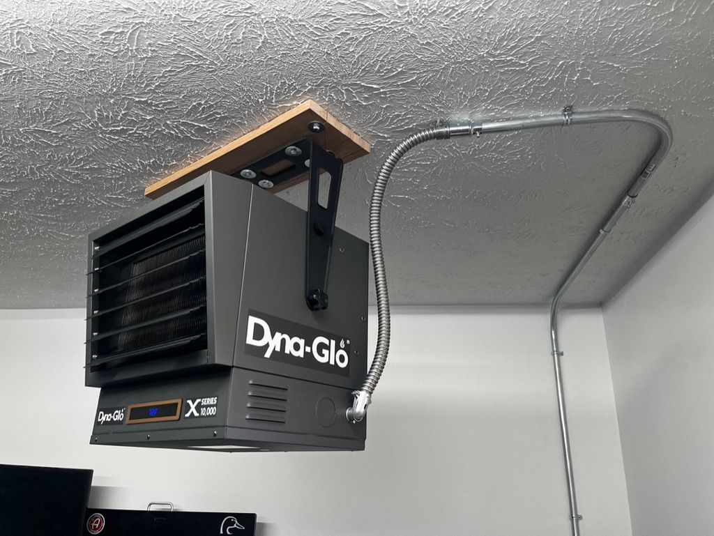 A dyna-glo heater is hanging from the ceiling