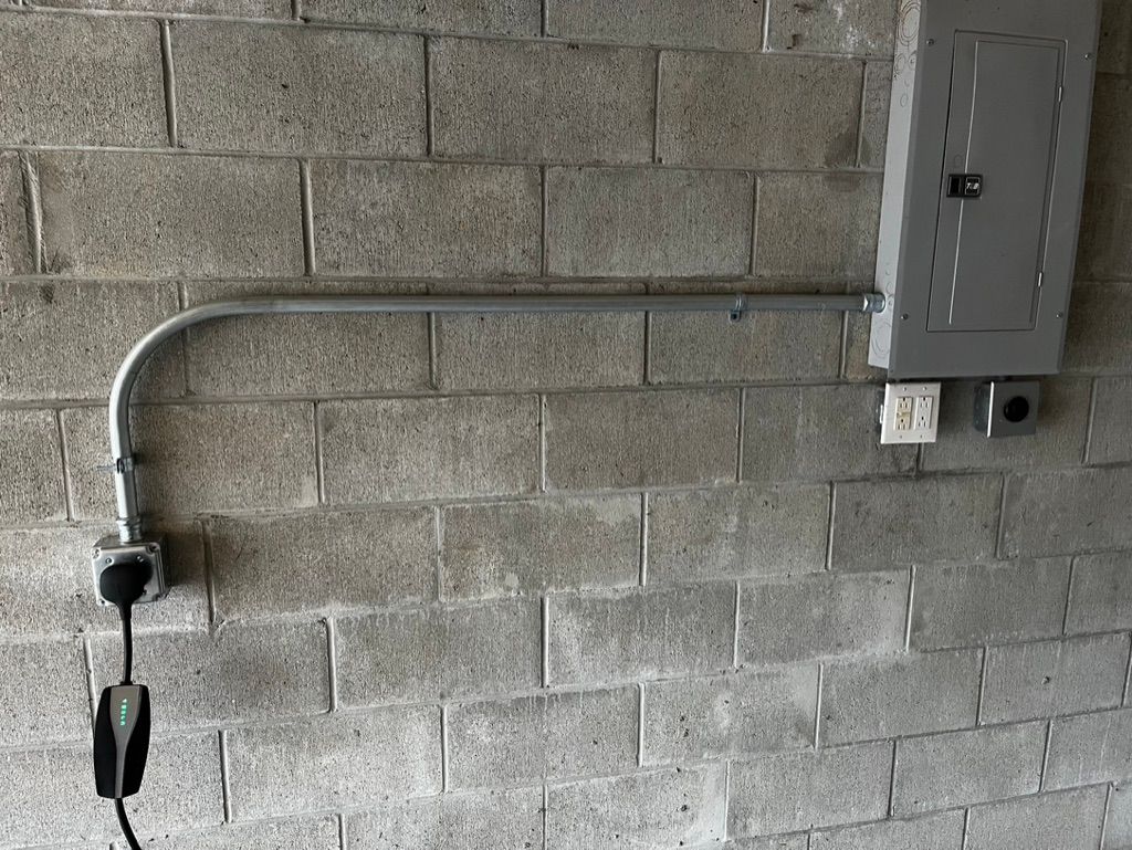 A power cord is plugged into a brick wall.