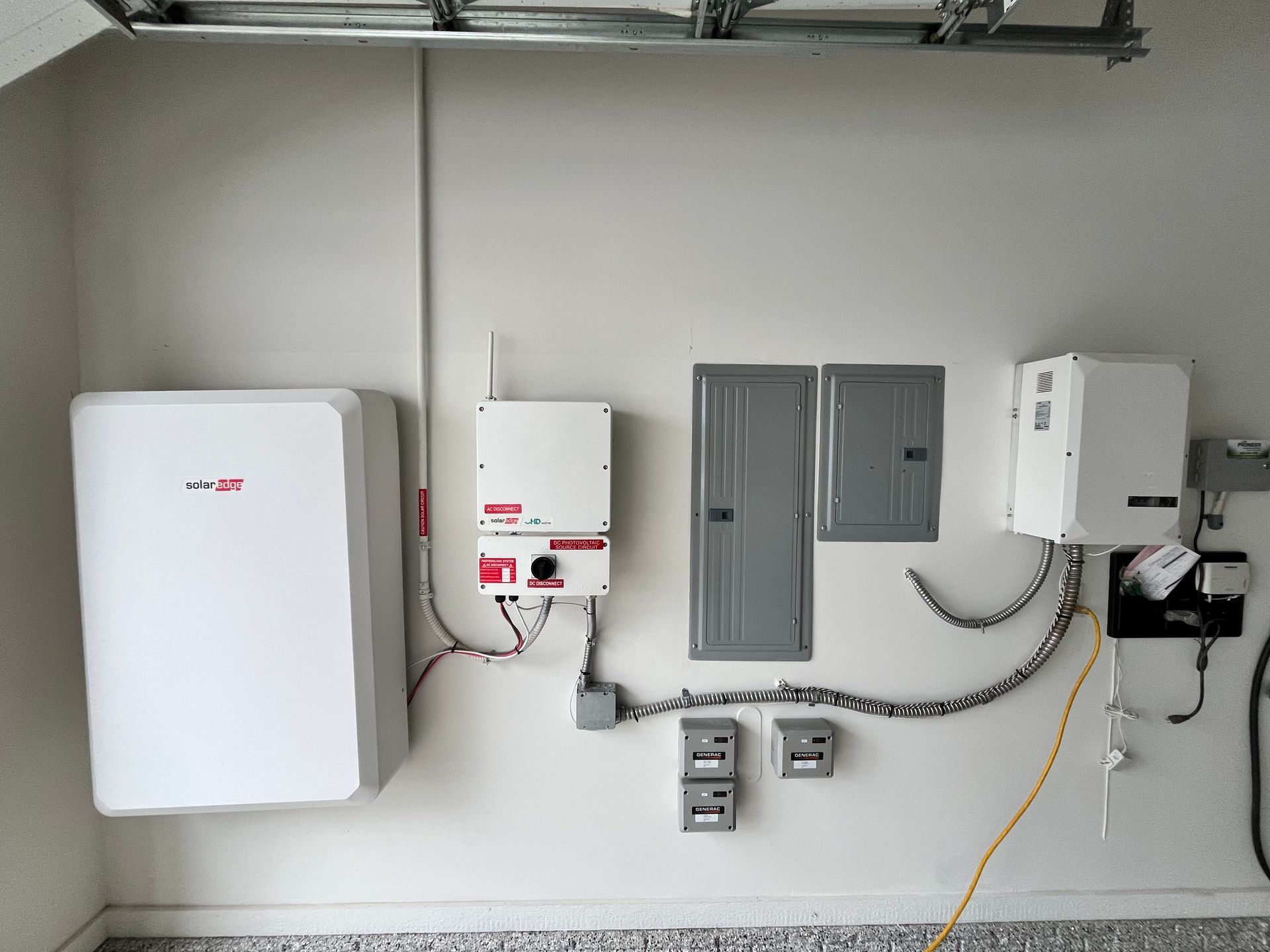 A garage with a lot of electrical equipment on the wall.