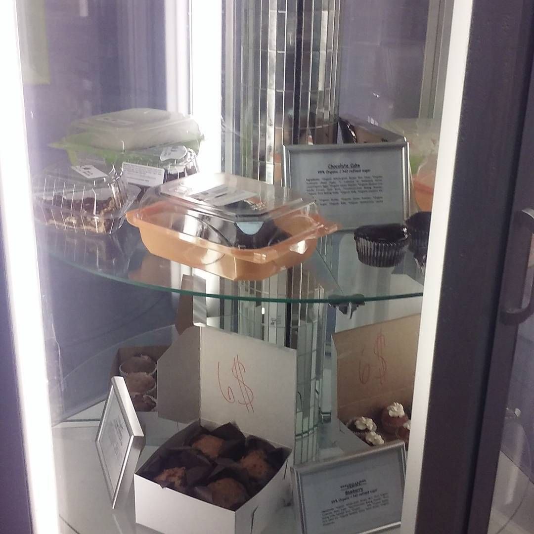 A glass display case filled with a variety of food items