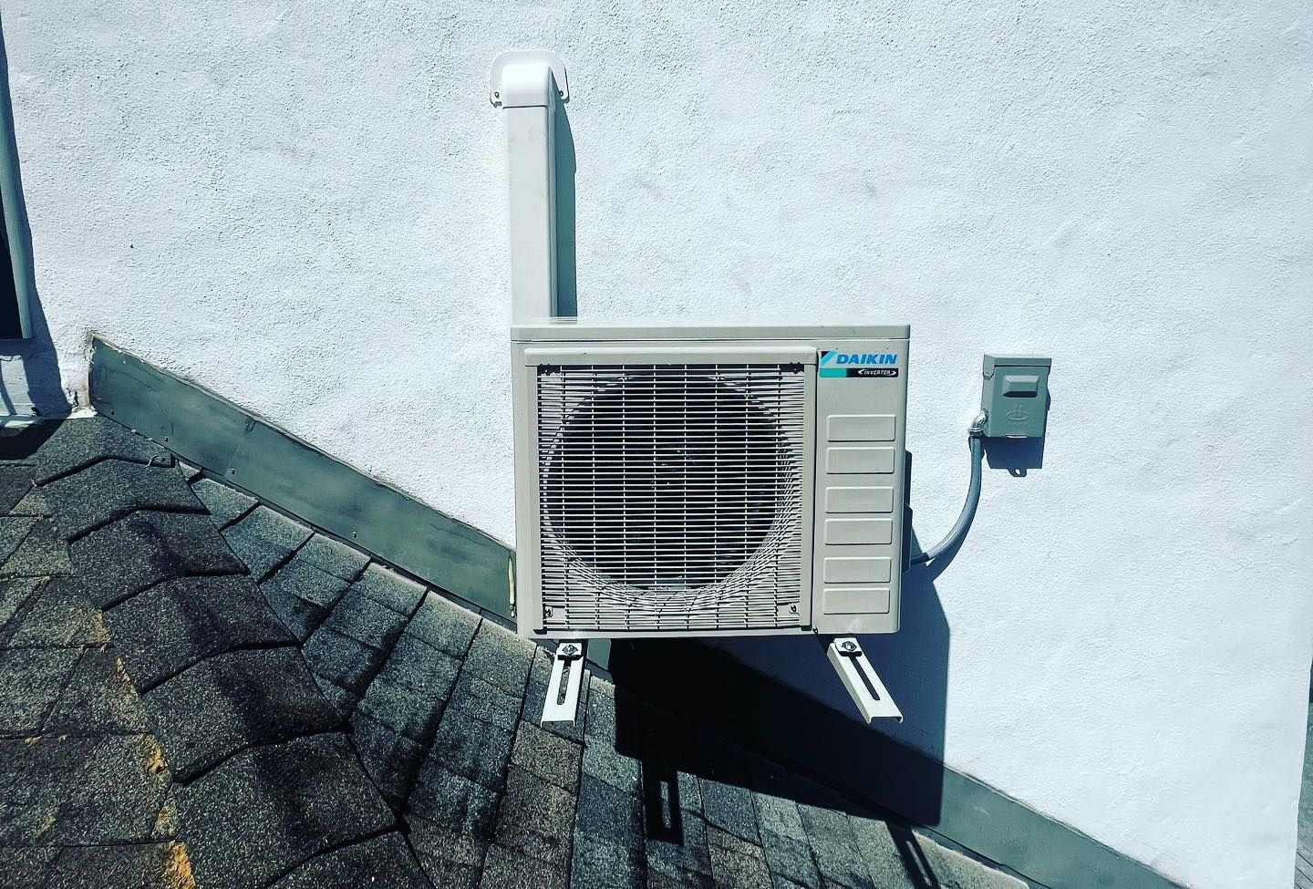 An air conditioner is mounted on the side of a building