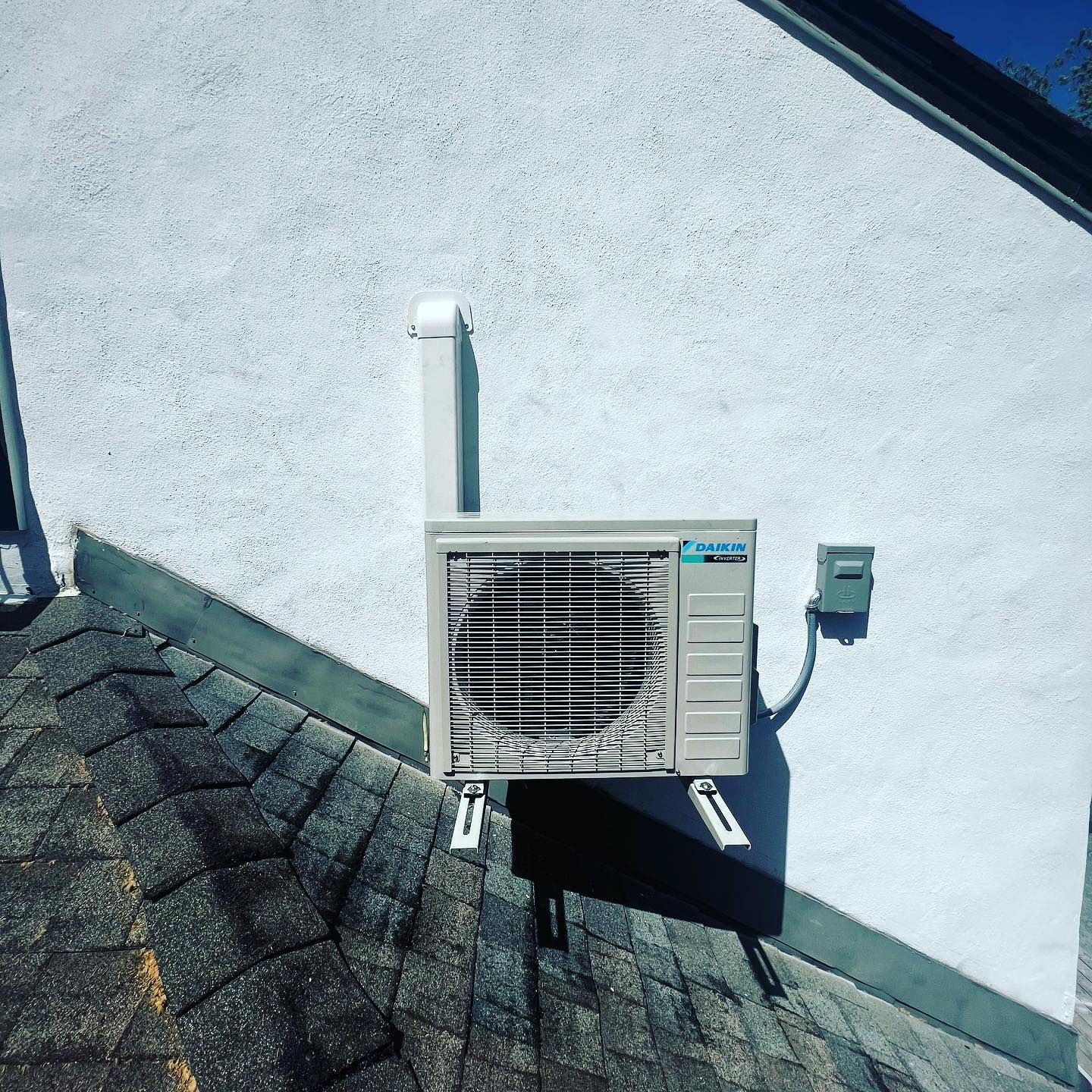 An air conditioner is mounted on the side of a building.