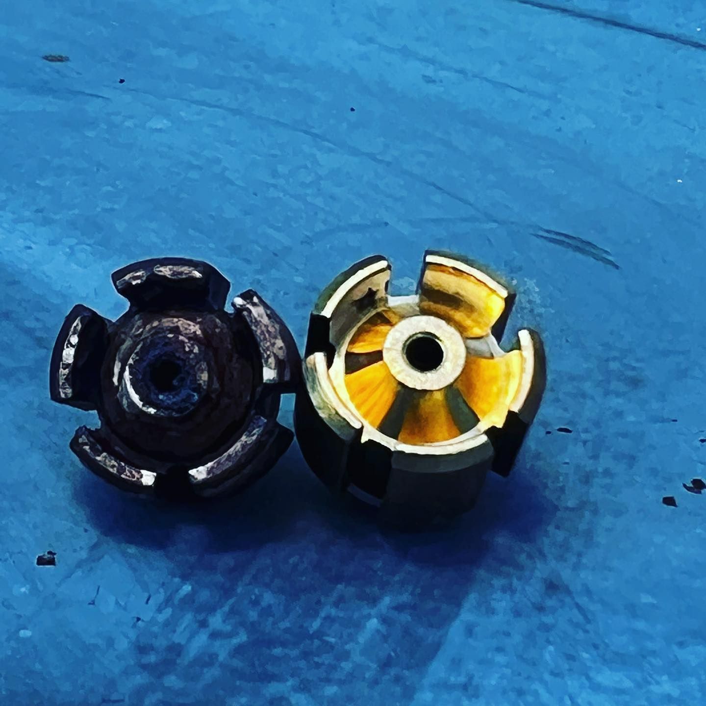 A black and yellow object with a hole in the middle on a blue surface