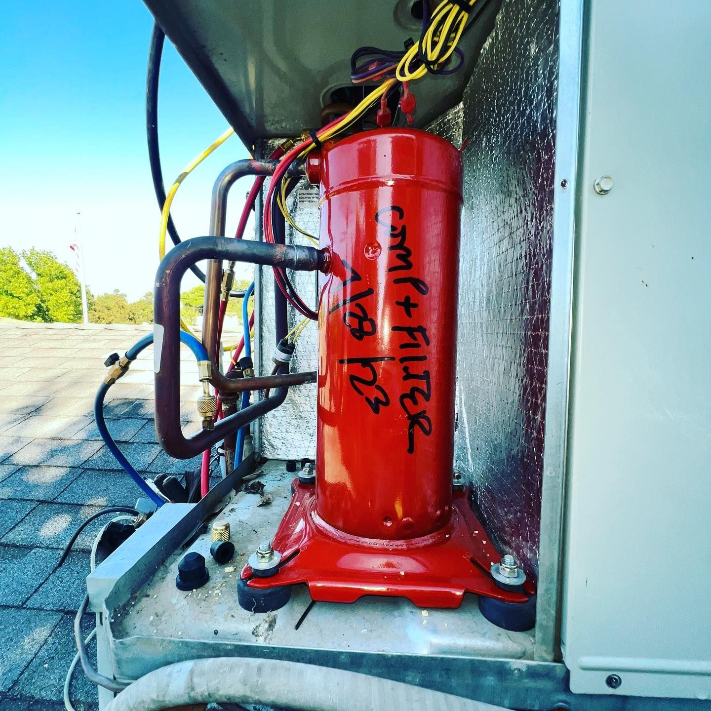 A red cylinder with the word compressor written on it