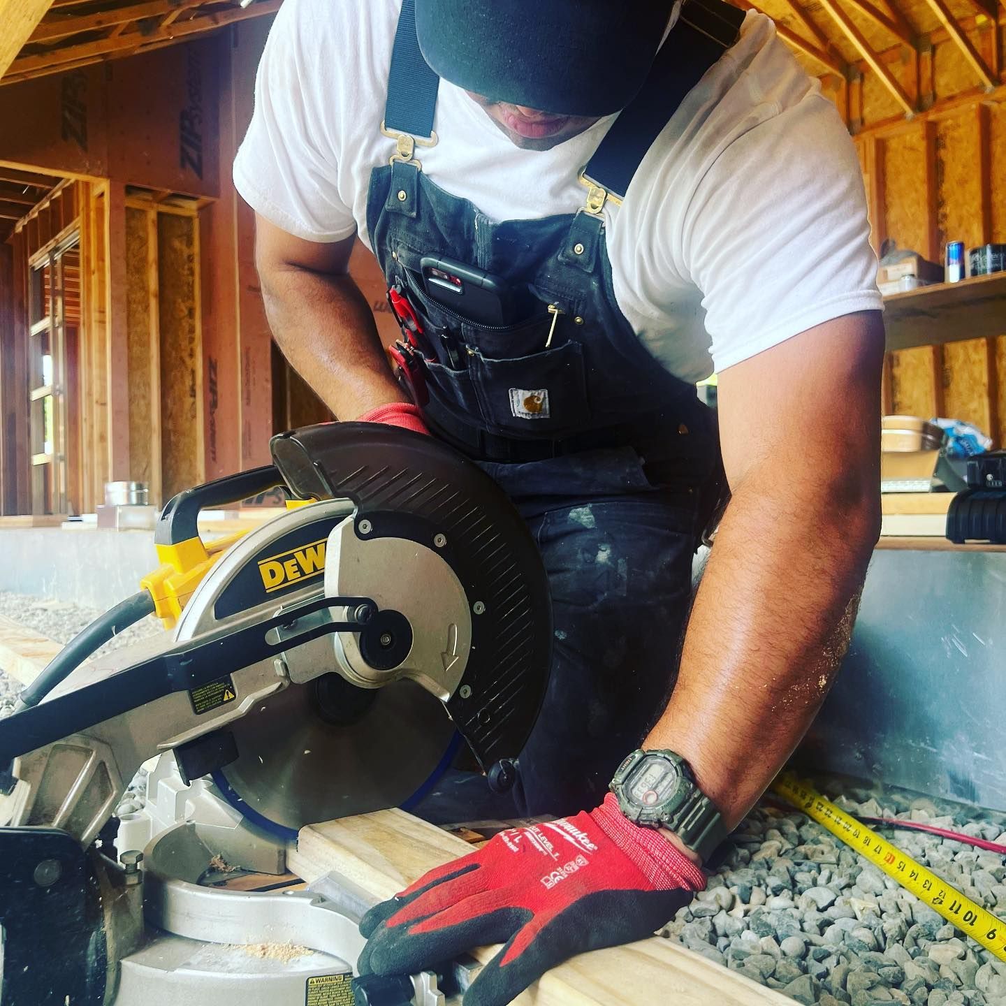 A man is using a dewalt circular saw to cut a piece of wood