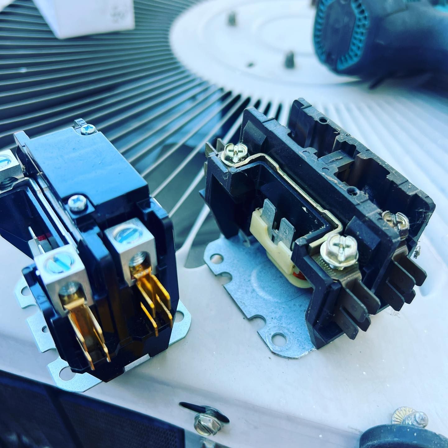 A pair of electrical connectors sitting on top of an air conditioner