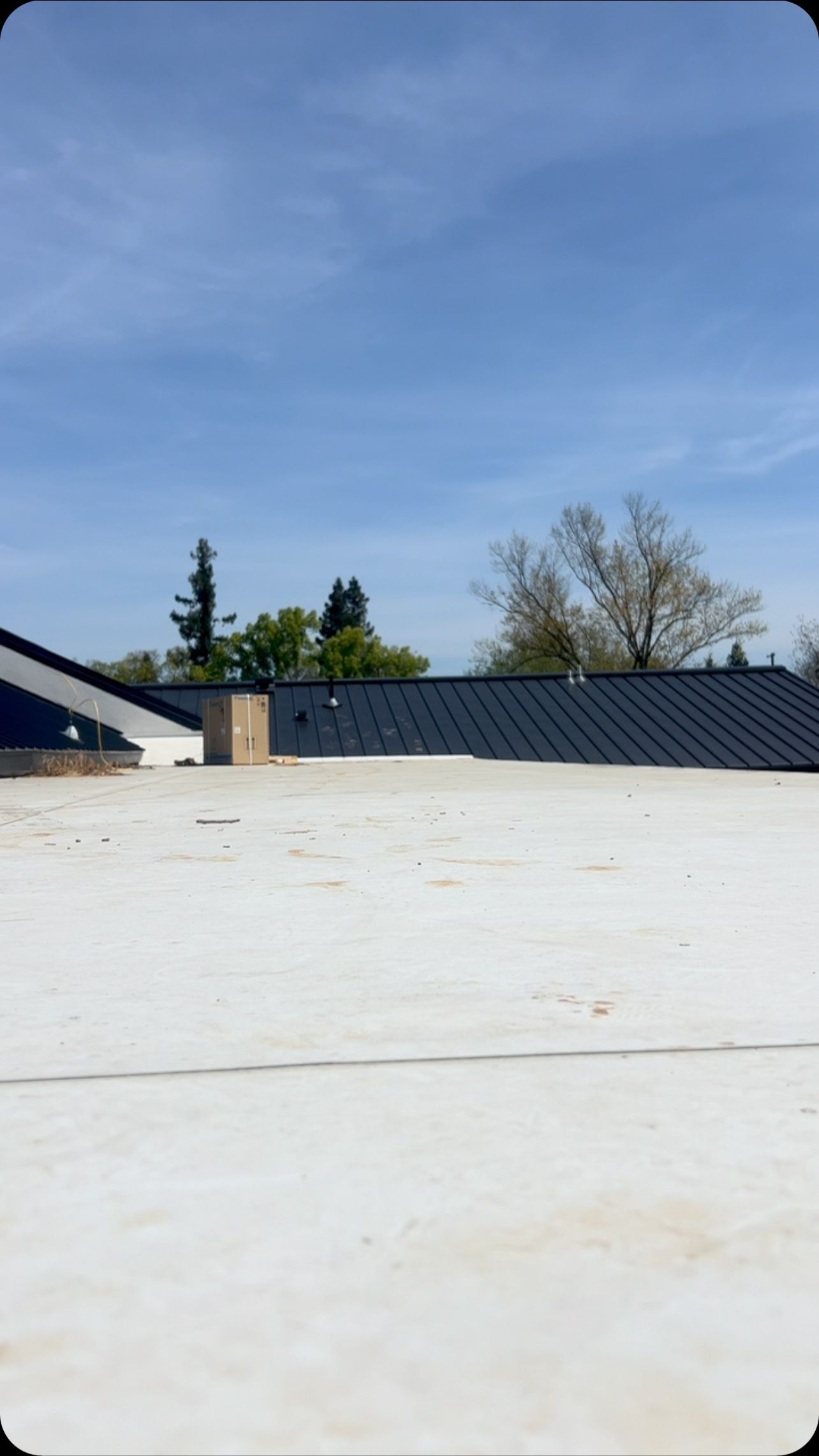 A white roof with a blue sky in the background.