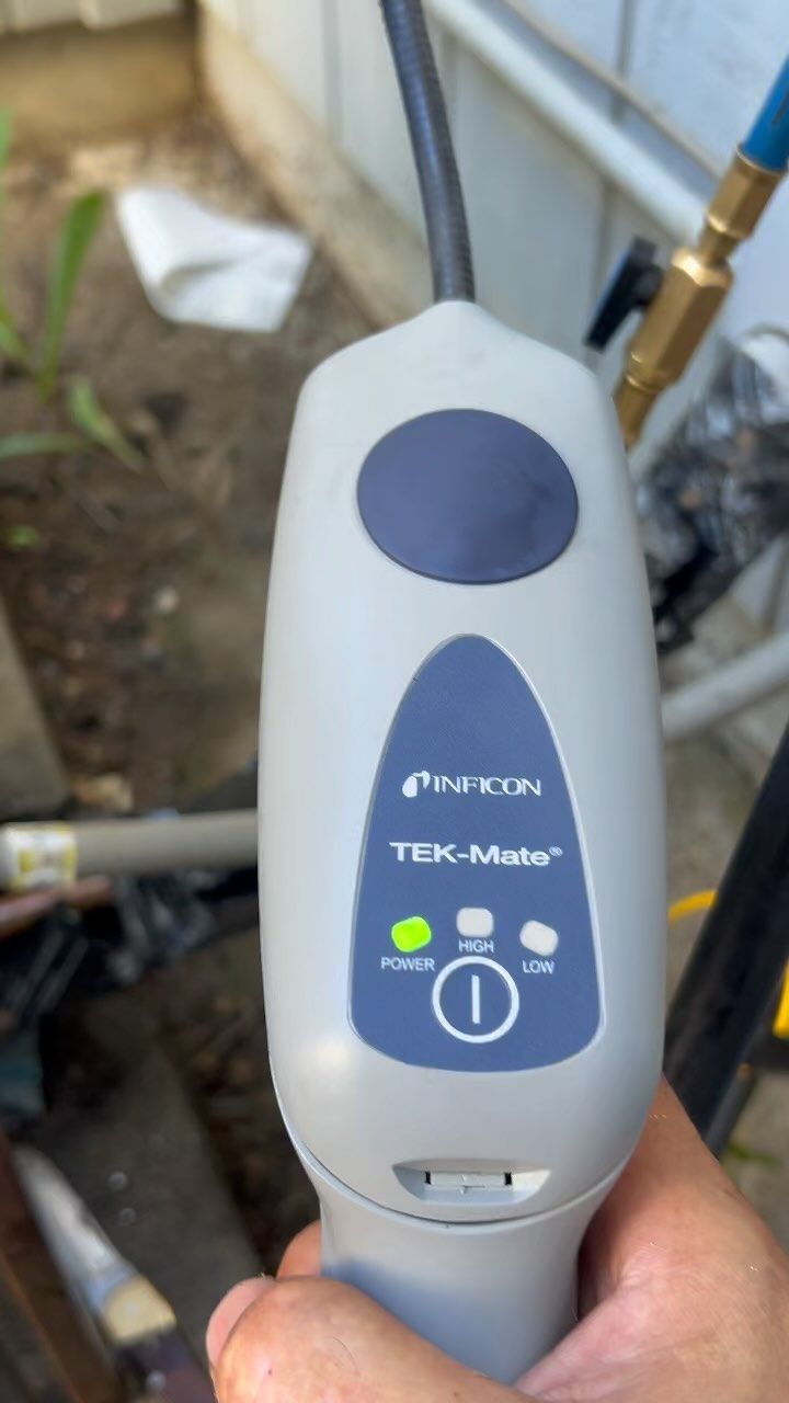 A person is holding a device that says tek-matrix on it