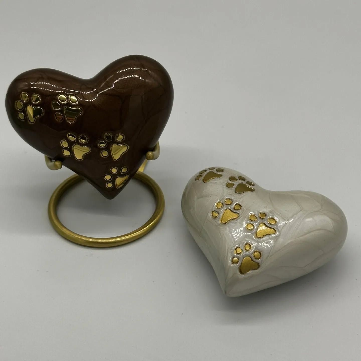 Two Heart-shaped Pet Urns, Brown and White, Decorated With Gold Paw Prints — Furever Pet Cremations in Rockhampton, QLD
