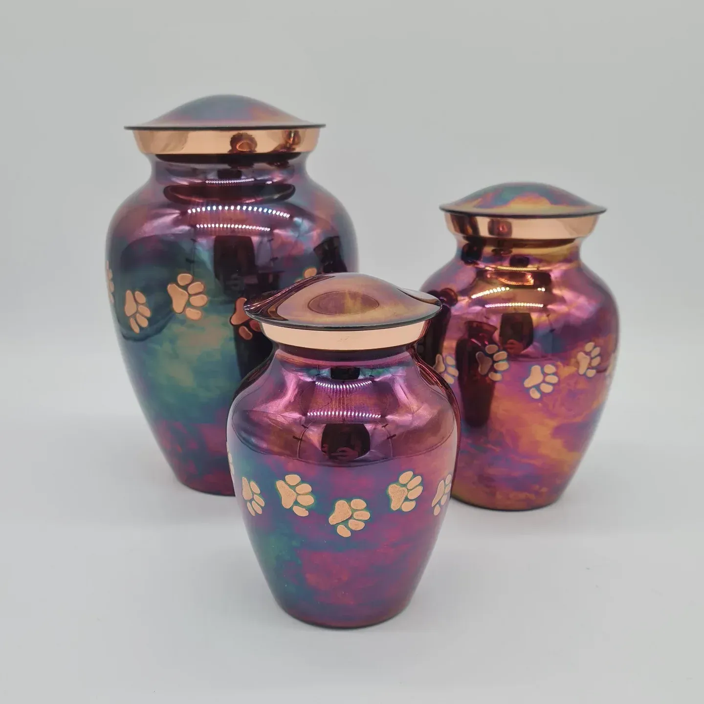 Three Iridescent Pet Cremation Urns With Copper Lids and Paw Print Accents — Furever Pet Cremations in Yeppoon, QLD