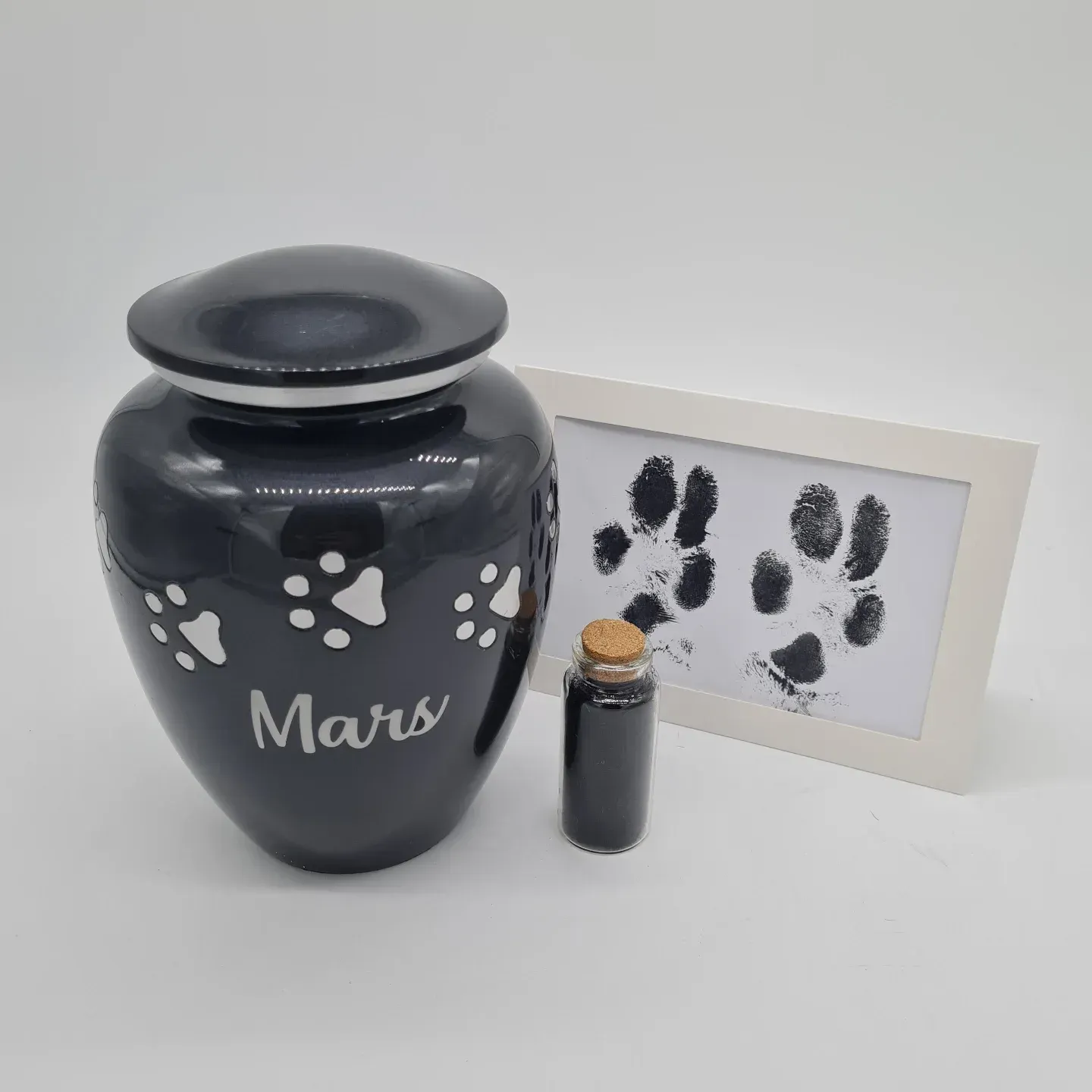 Black Pet Cremation Urn With Paw Prints and Name — Furever Pet Cremations in Rockhampton, QLD