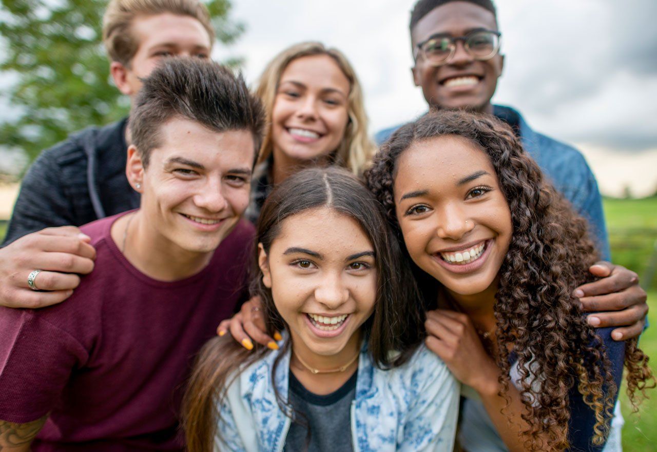 Group of teens smiling — Montgomery, AL — David S Leslie DMD Family Dentistry