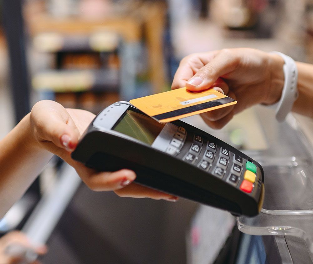 A person is using a credit card to pay for something.