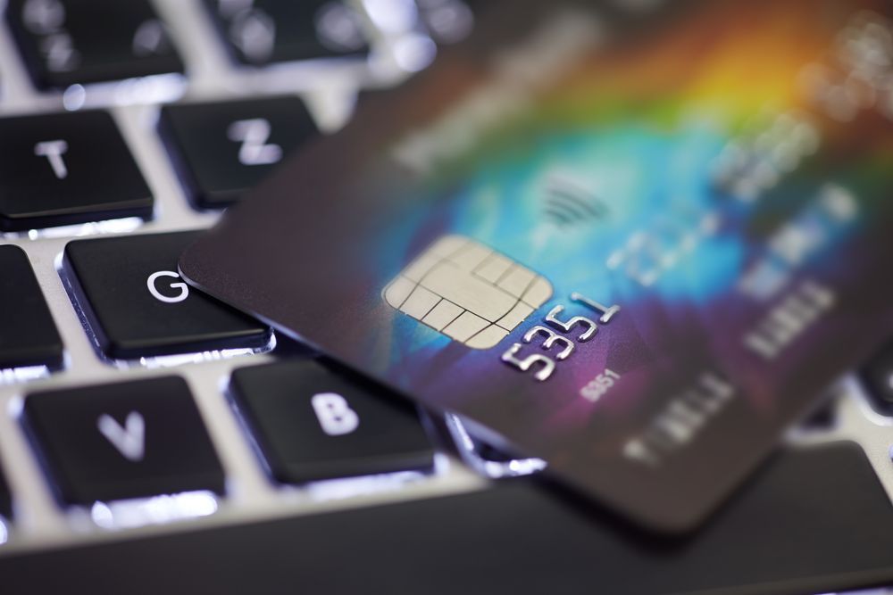 A close up of a credit card on top of a keyboard