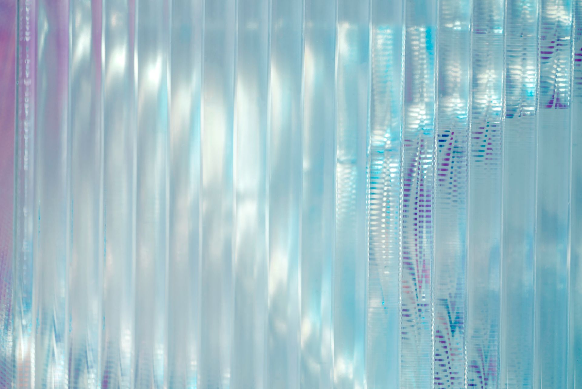 A close up of a blue curtain with a reflection of the sun.