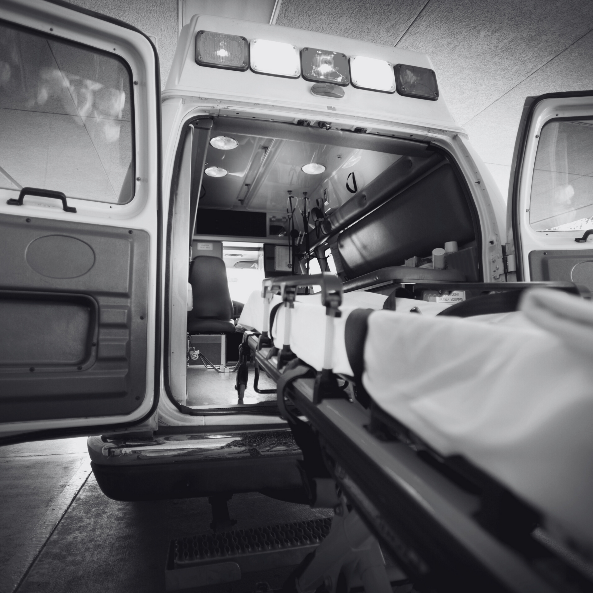 Ambulance outside a hospital, symbolizing Ambulance Sublimits in Occupational Accident Insurance.