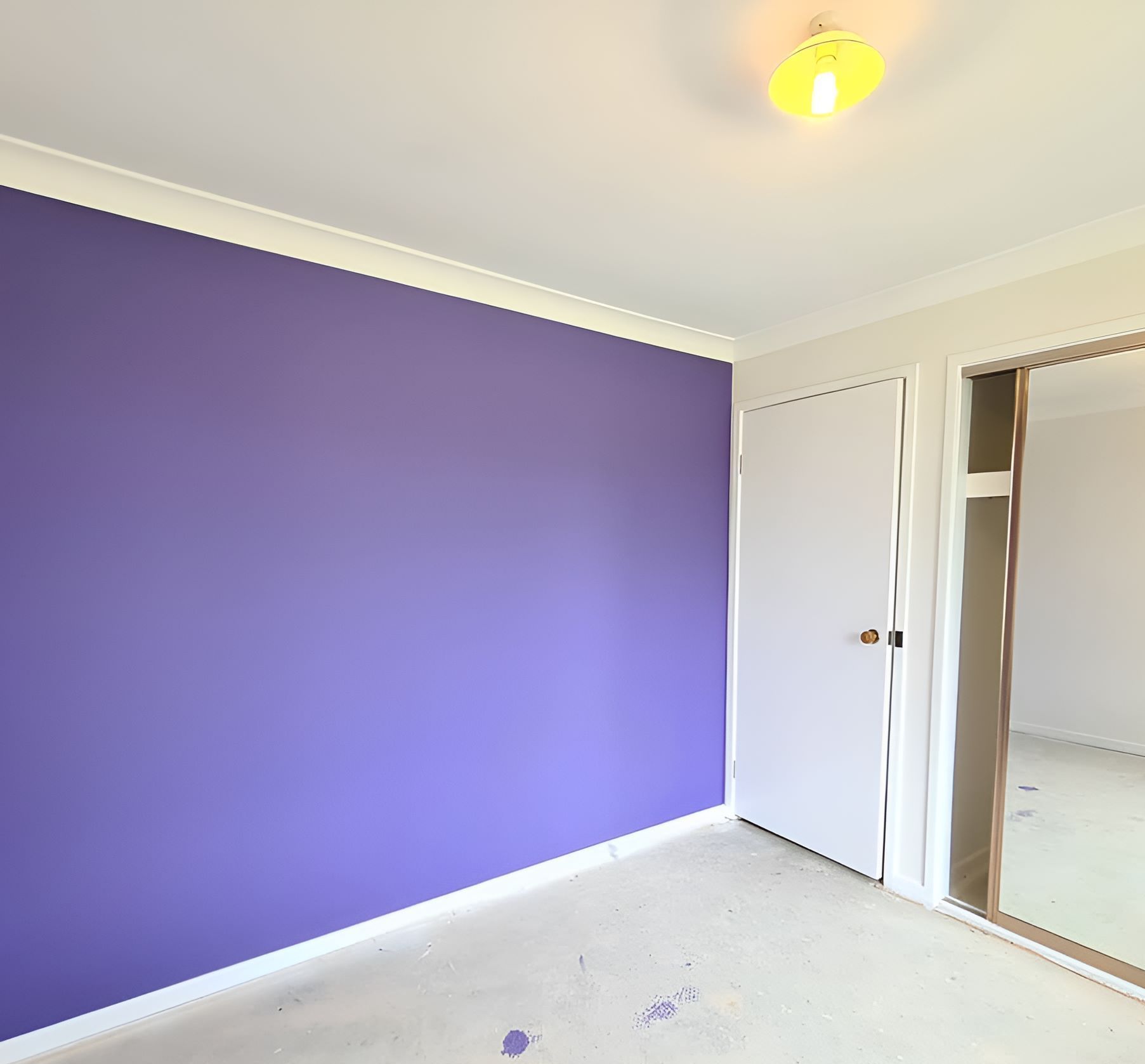 An Empty Room With a Purple Wall and a Mirror — JAX Painting Services in Central Coast, NSW