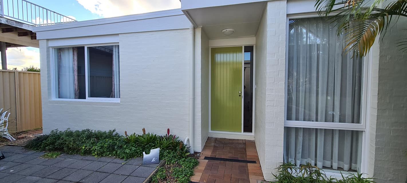 A White House With a Green Door and Two Windows — JAX Painting Services in Central Coast, NSW
