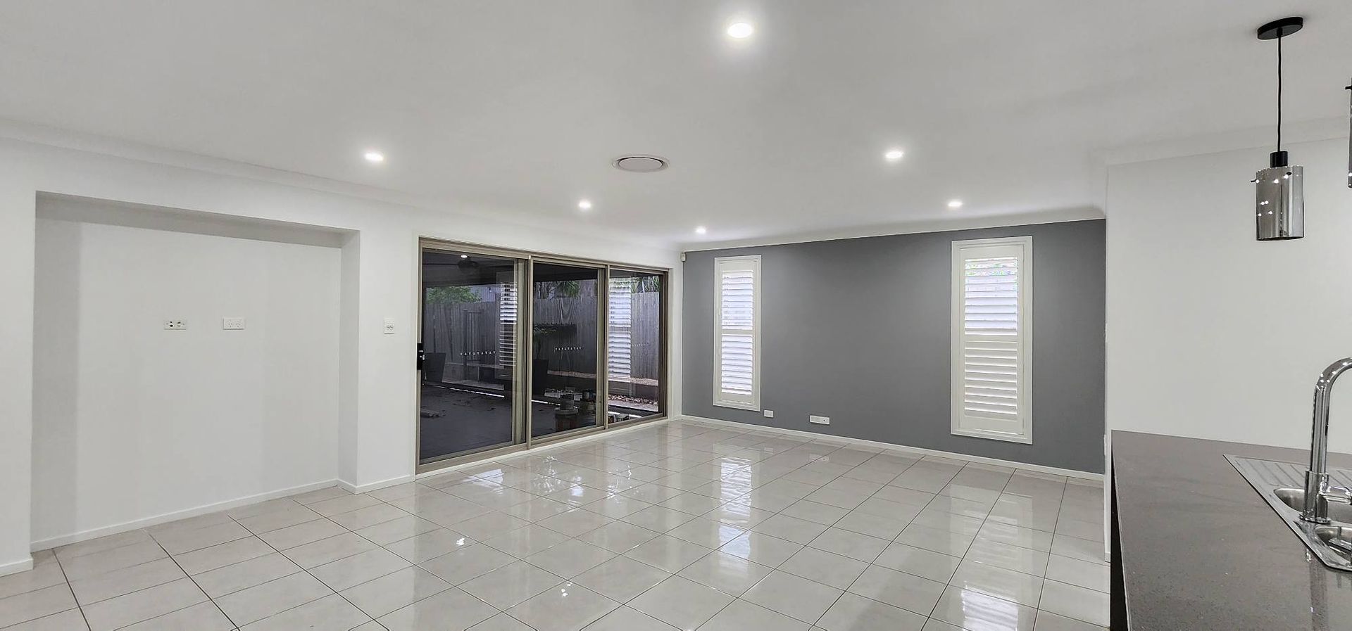 A Large Empty Room With a Marble Floor and White Walls — JAX Painting Services in Central Coast, NSW