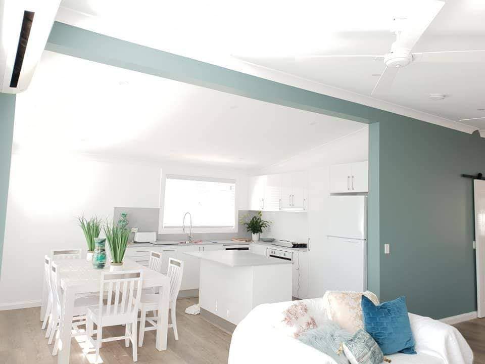 A Living Room With a Dining Table and Chairs and a Kitchen — JAX Painting Services in Central Coast, NSW