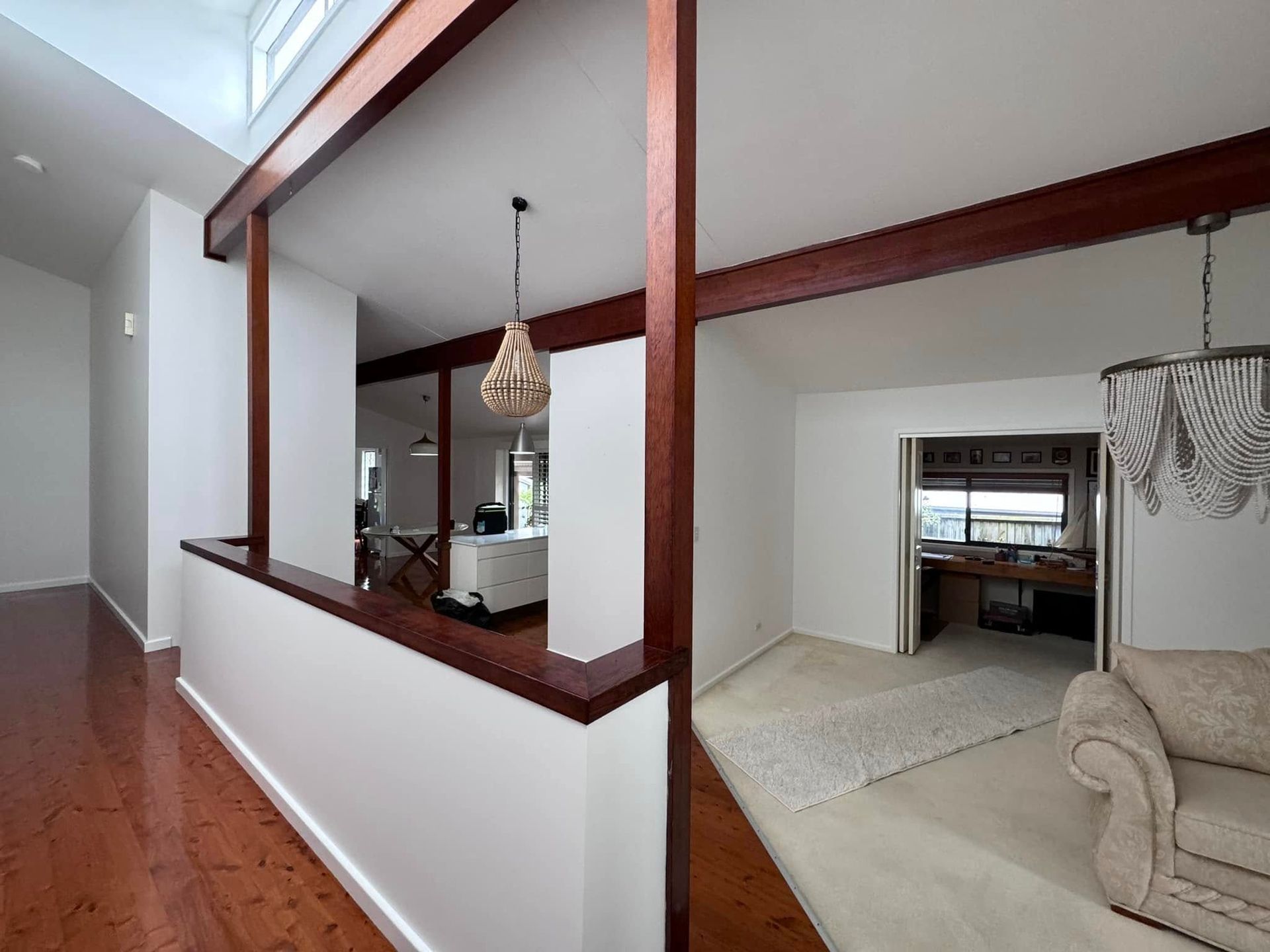 A Living Room With Hardwood Floors and White Walls — JAX Painting Services in Central Coast, NSW