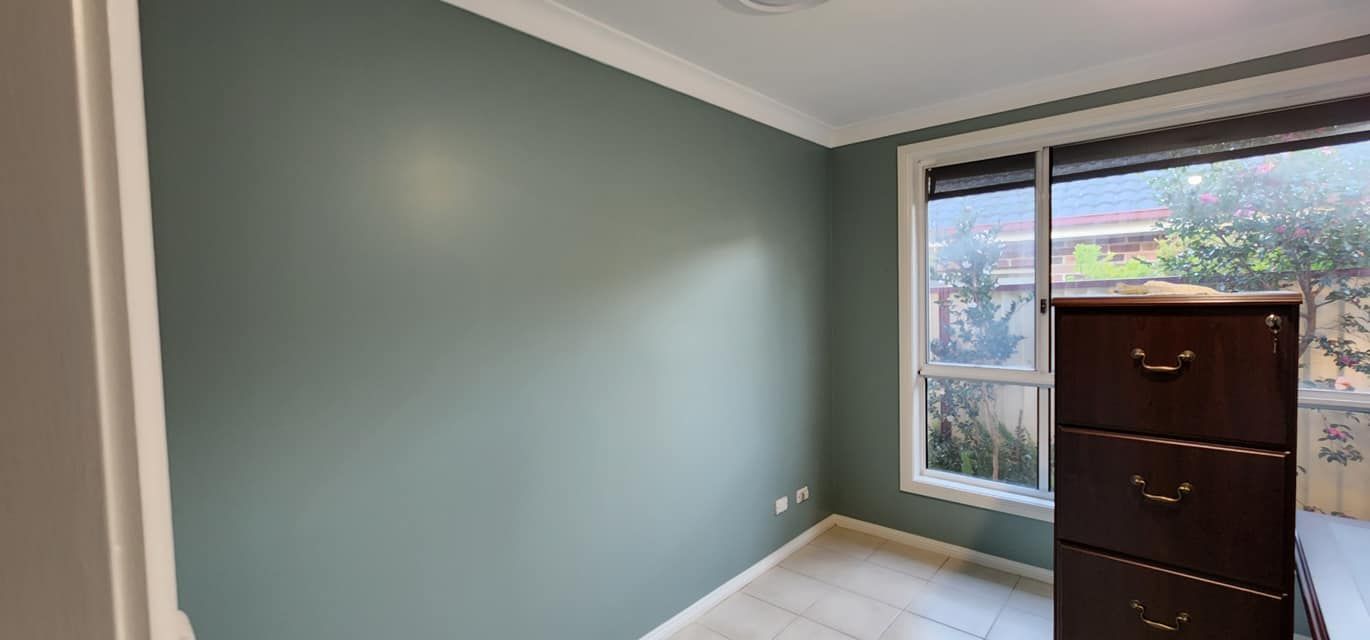 An Empty Room With a Dresser and a Window — JAX Painting Services in Central Coast, NSW
