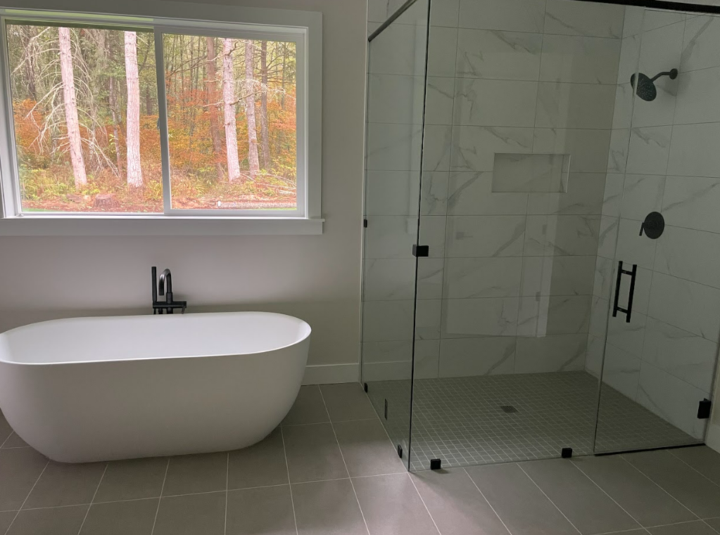 A bathroom with a bathtub and a walk in shower.