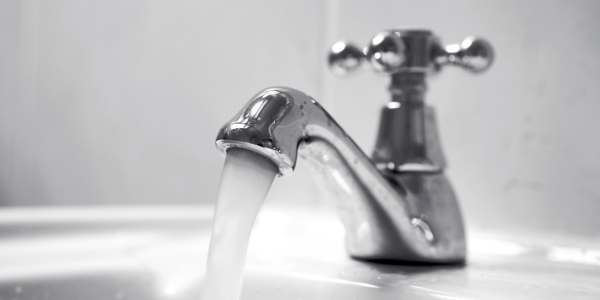 A bathroom faucet with flowing water