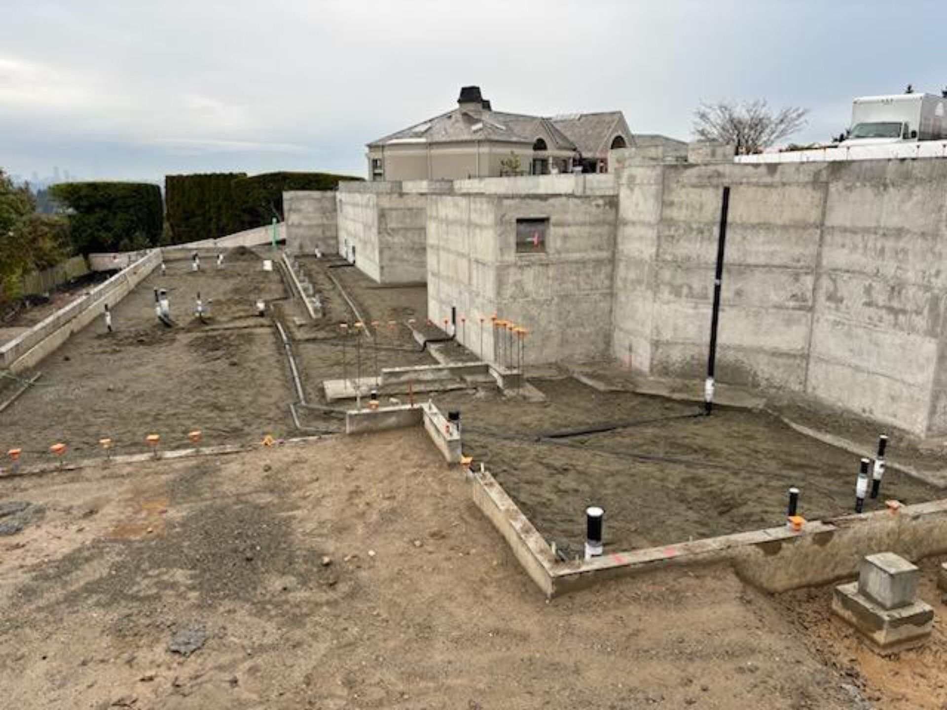 A large concrete structure is being built where rough in plumbing is being performed for the foundation