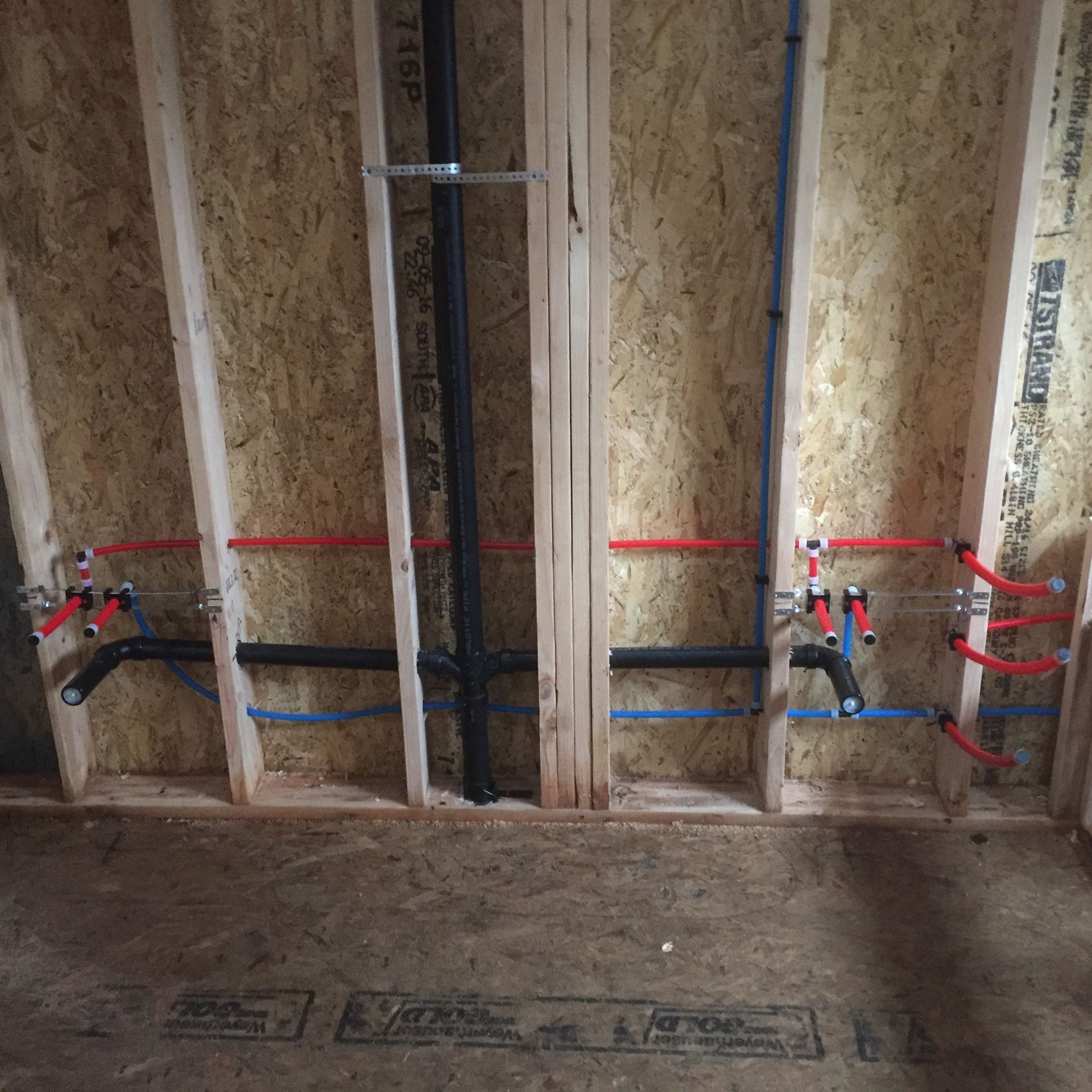 A wall with a lot of pipes going through it