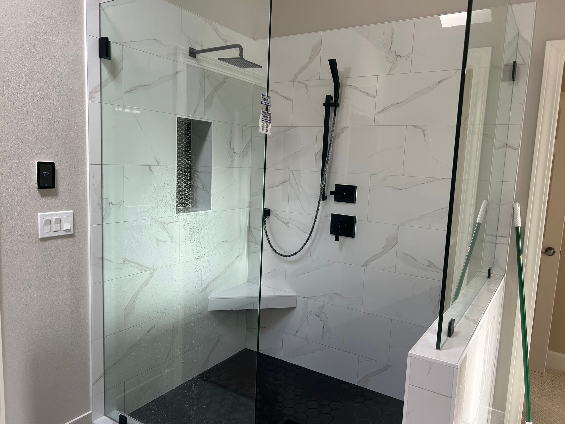 A walk in shower with two heads installed by Royal Flush Plumbing in Tacoma