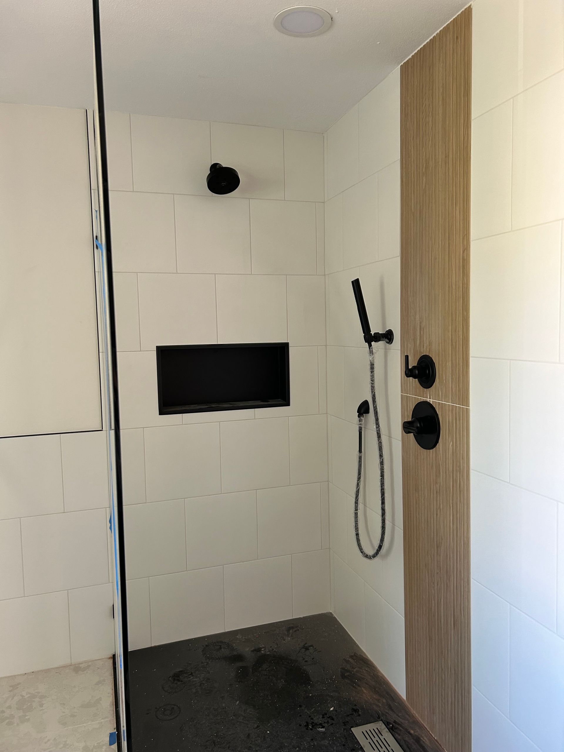 A bathroom with a walk in shower with two heads installed by Royal Flush Plumbing in Tacoma