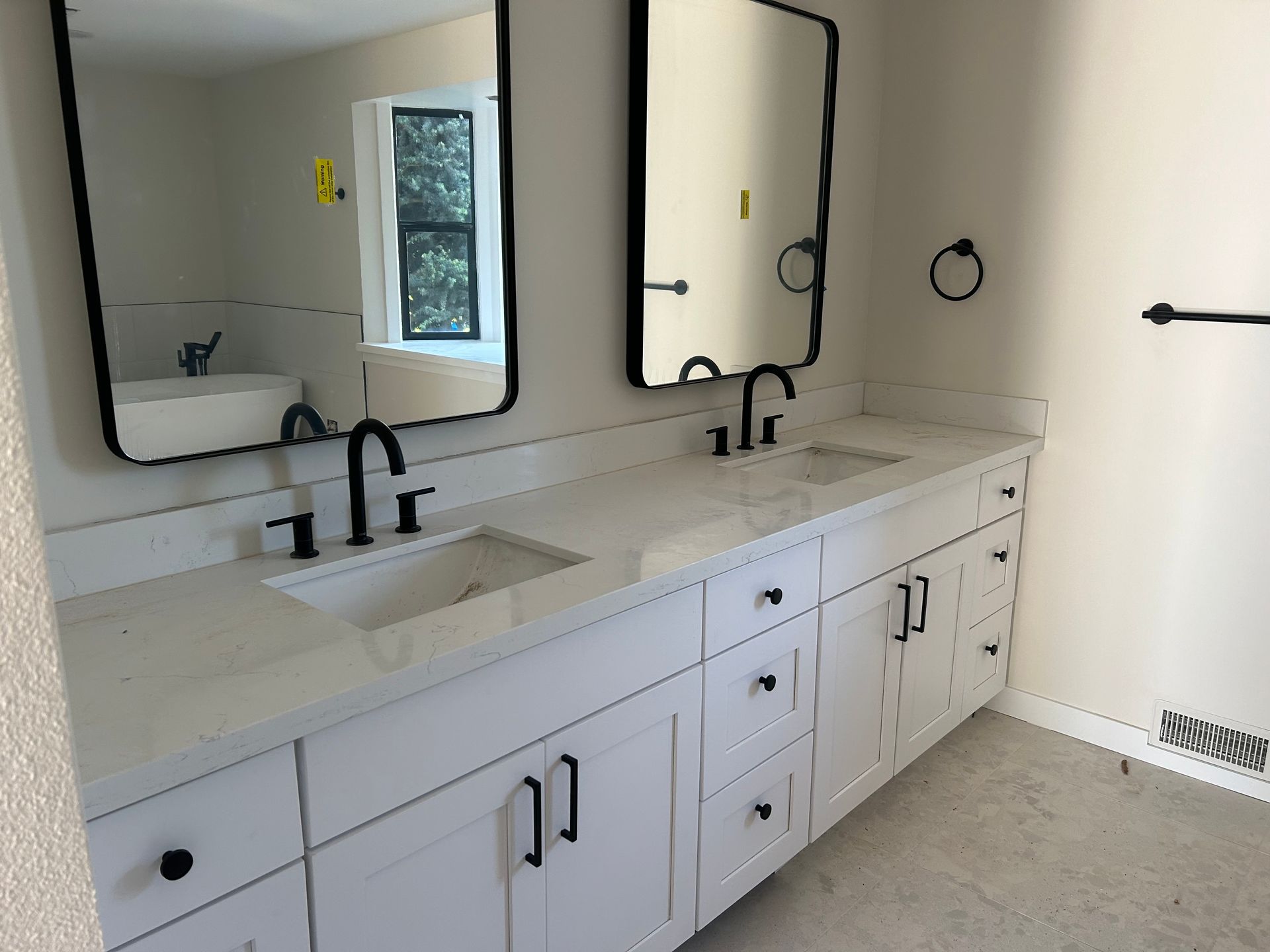 A bathroom with two sinks installed by Royal Flush Plumbing in Tacoma