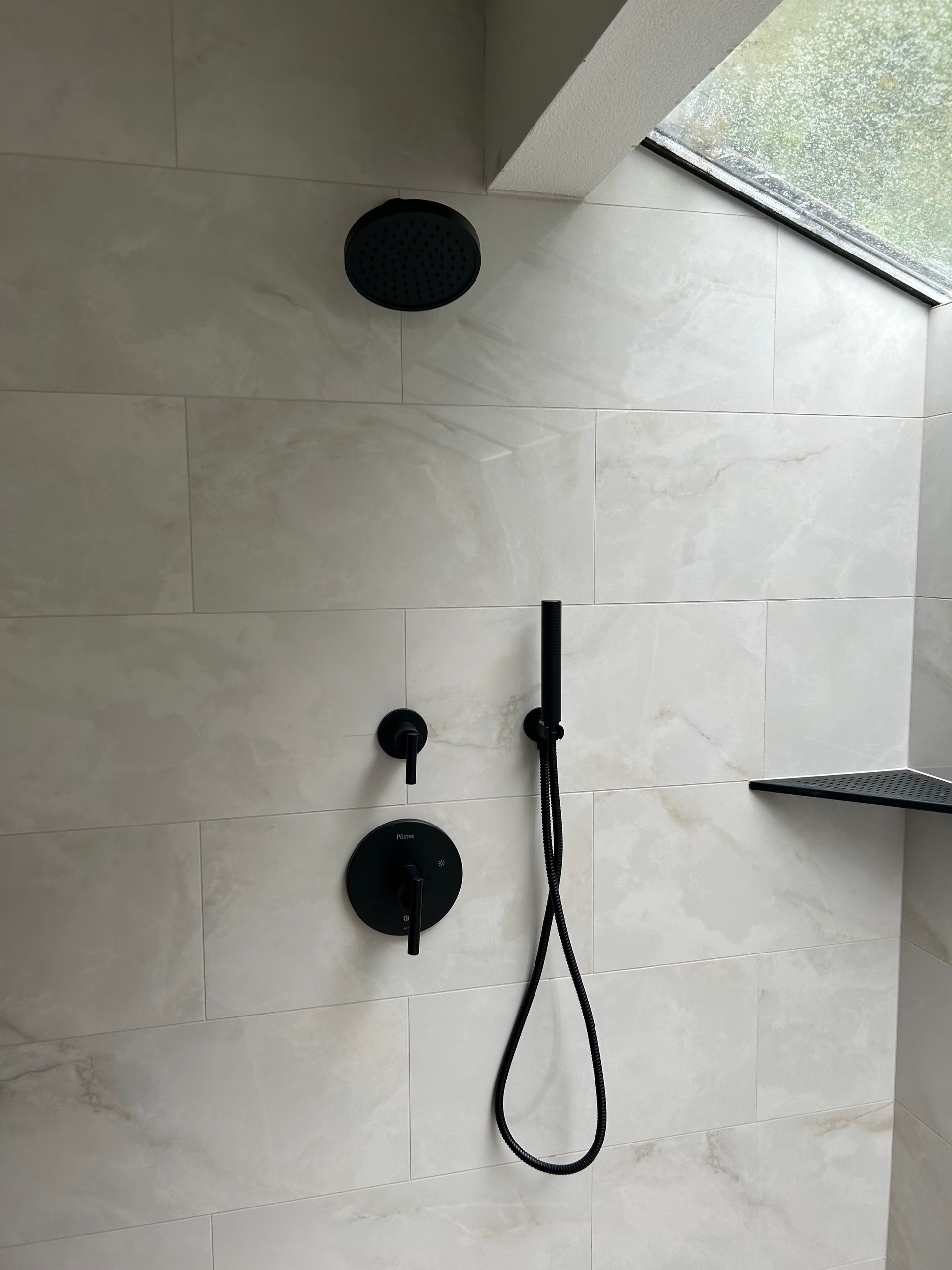 A black shower head installed by Royal Flush Plumbing in Tacoma