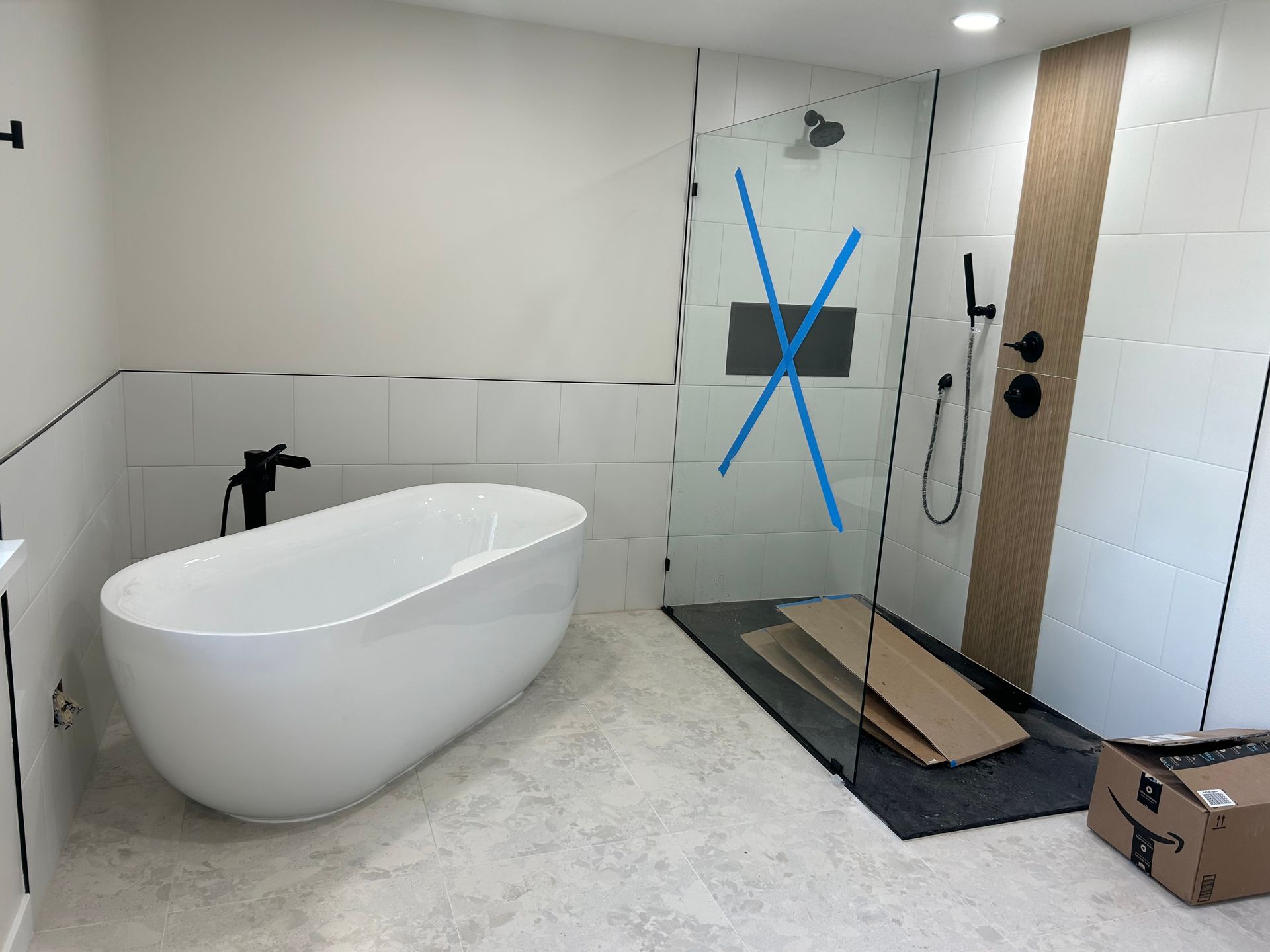 A bathroom with a bathtub and a walk in shower installed by Royal Flush Plumbing in Tacoma