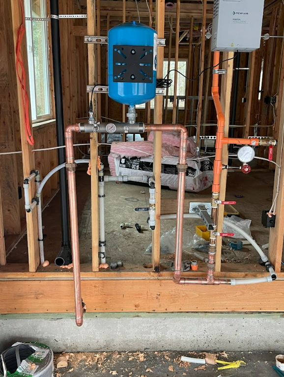A plumbing system is being installed in a house under construction.
