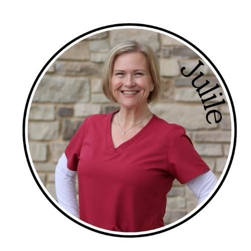 Woman smiling in a red shirt, standing before a stone wall inside a circular portrait with the name “Julie.”