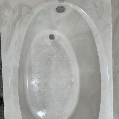 Oval white bathtub with swirling grey accents.