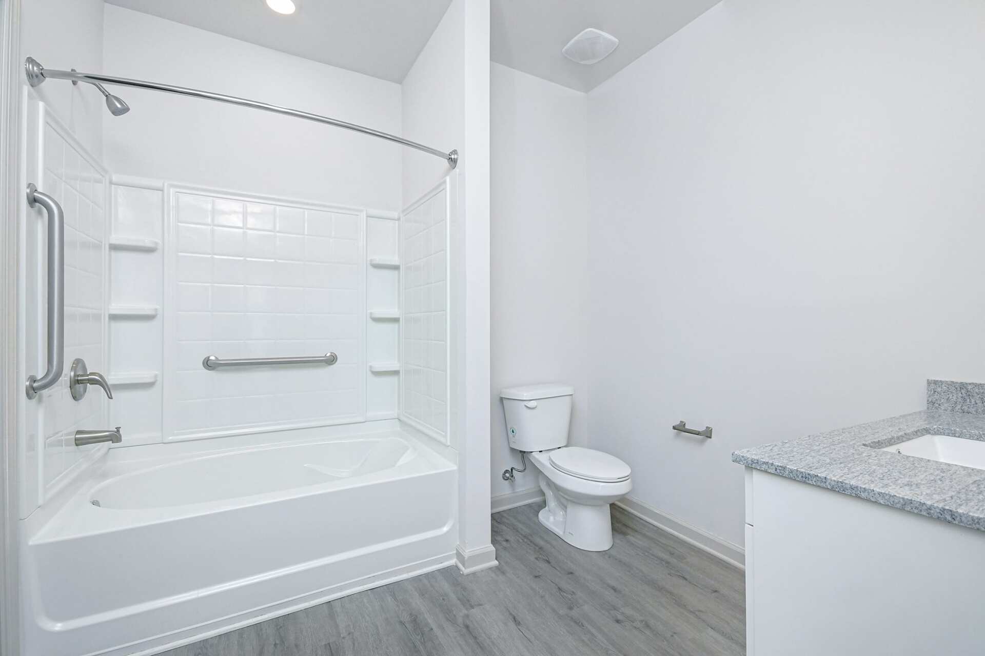 The Blakely bathroom with sink, toilet, and shower/bath.