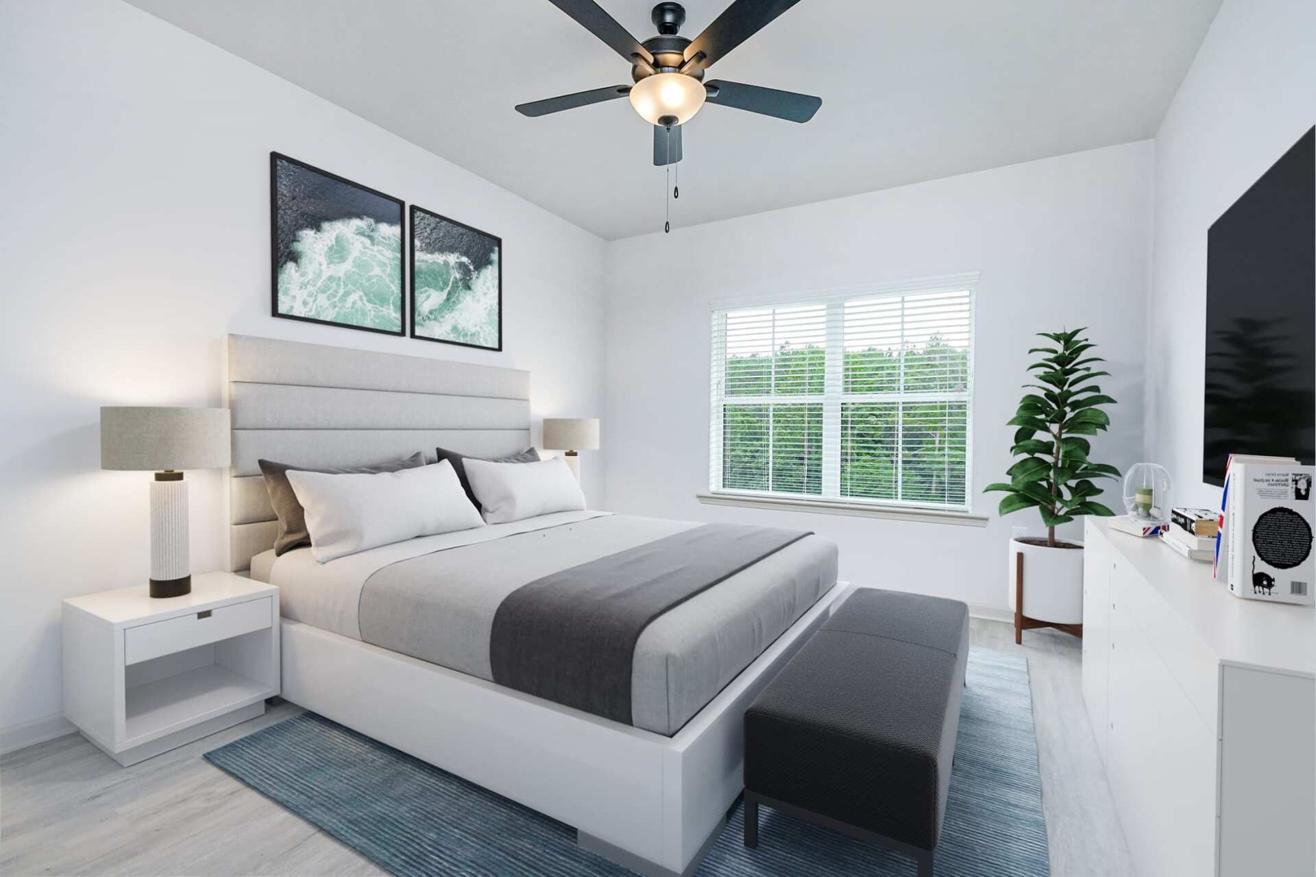 The Blakely spacious bedroom with bed, rug, ceiling fan, and windows.