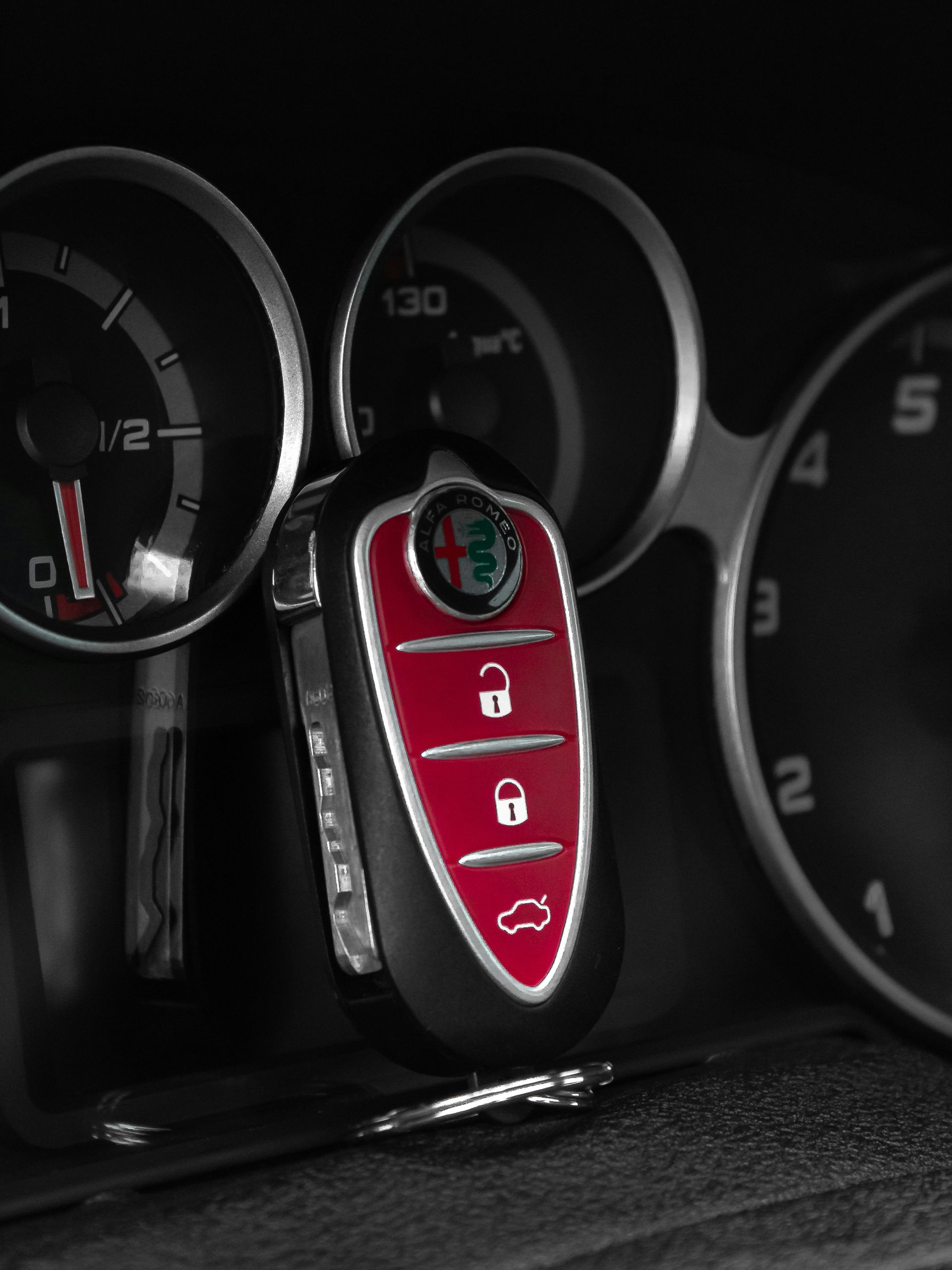 A close up of a car key on a dashboard