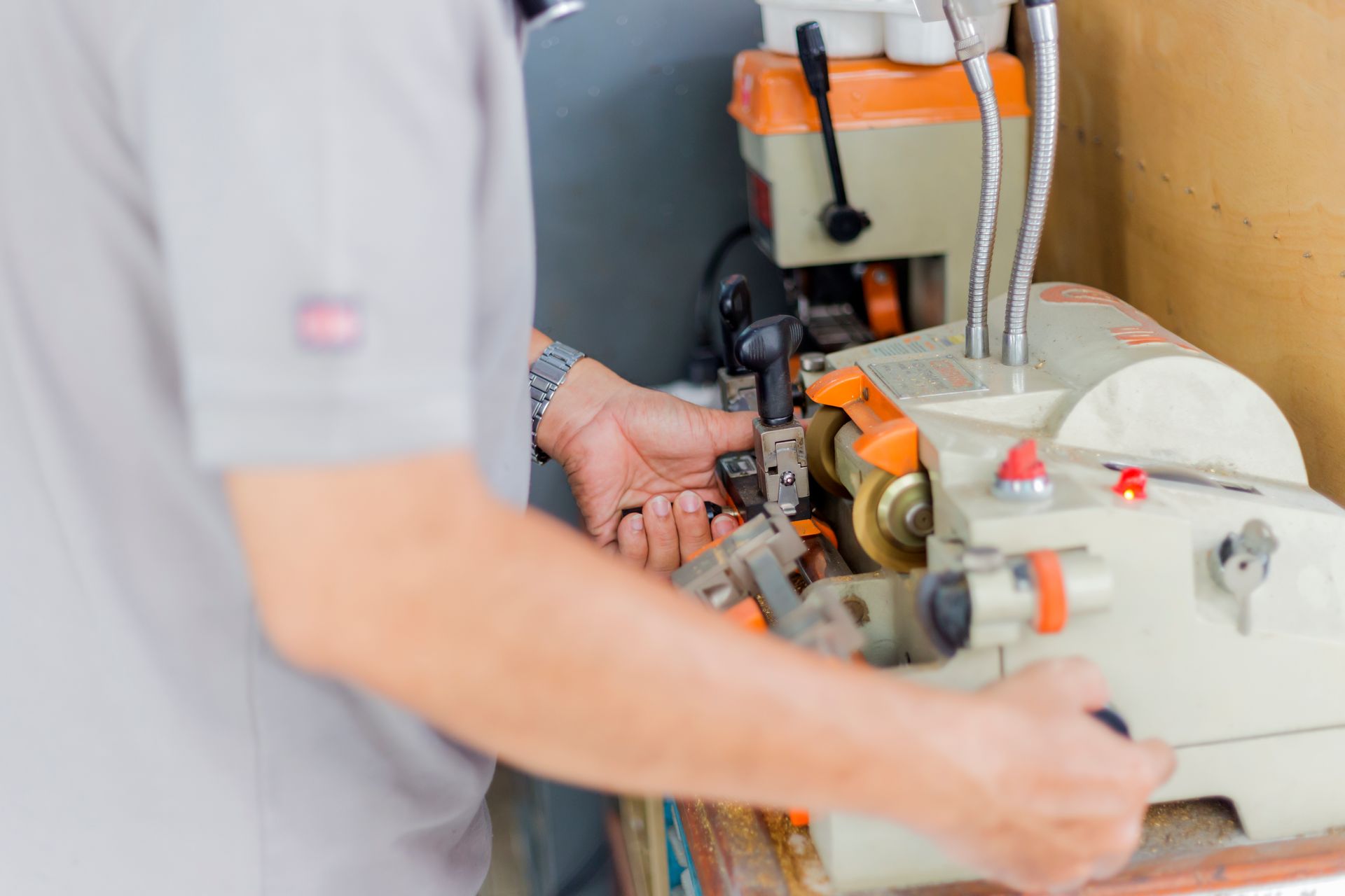 A man is using a machine to make keys.