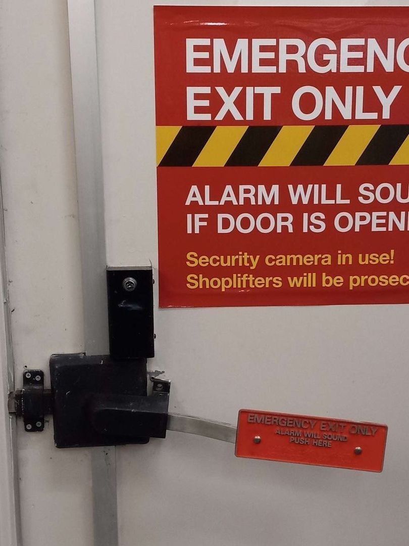Emergency exit door with red sign: 