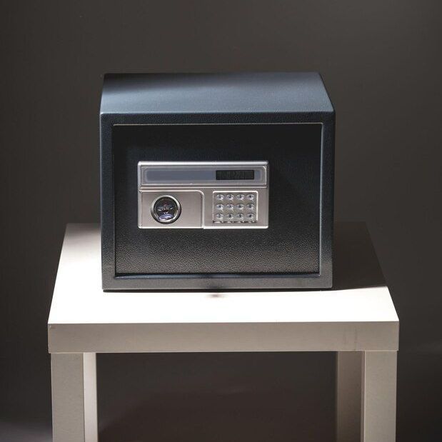 A safe is sitting on top of a white table