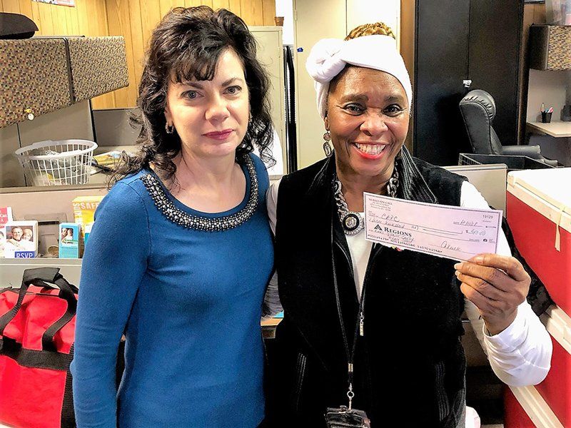 Nurse Staffing — Laura Worthylake with a Woman Holding a Check in Pensacola, FL