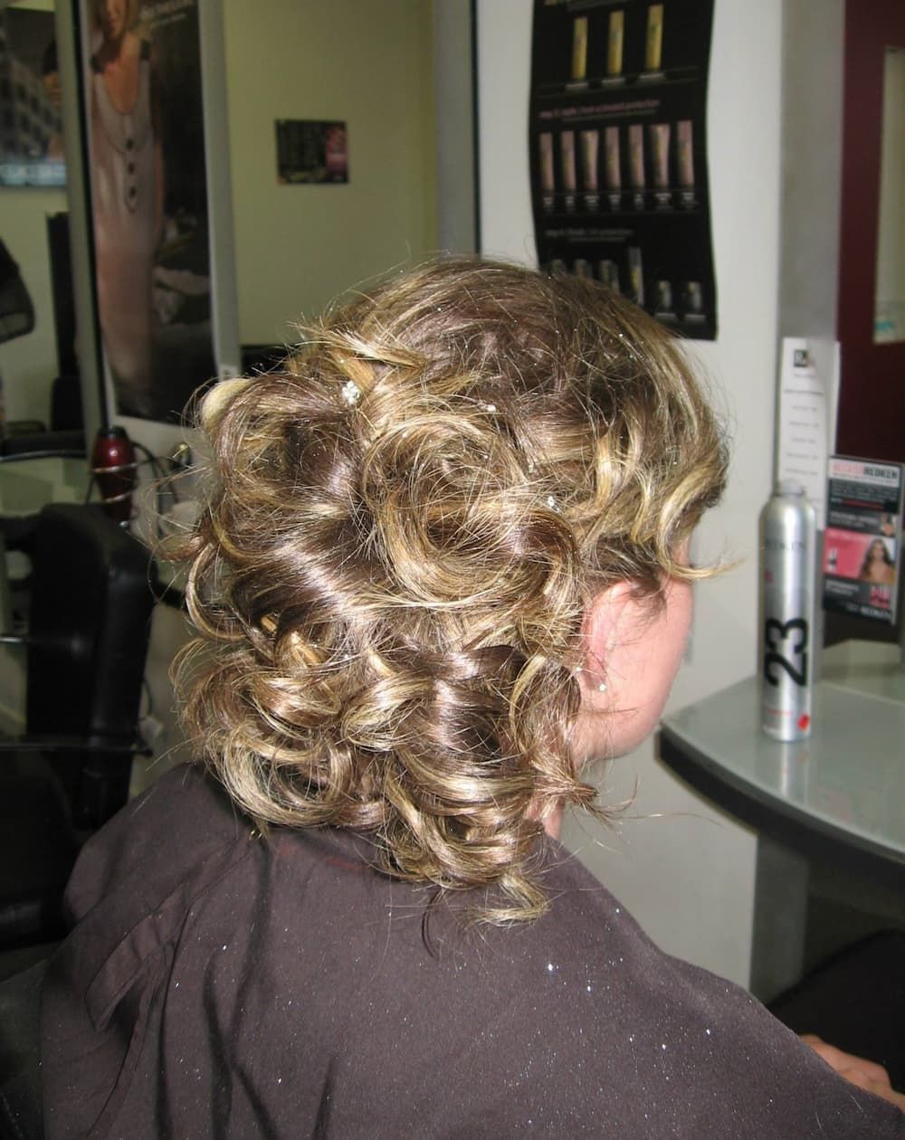 A Woman is Getting Her Hair Done in a Salon — Rayzr Hair Artistry in Eli Waters, QLD