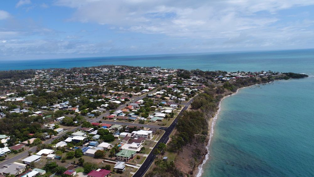 An Aerial View of a Small Town Next to the Ocean — Rayzr Hair Artistry in Hervey Bay, QLD