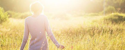 cremation vs burial woman walking through field