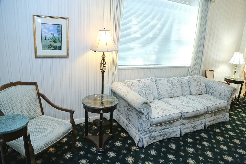 funeral home facilities room with white sofa and chair